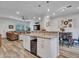 Open concept kitchen and living room featuring wood floors, granite countertops and wine fridge at 18820 N 34Th Ln # 1, Phoenix, AZ 85027