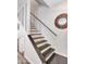 Stylish staircase featuring a black handrail and wooden sunburst mirror at 18820 N 34Th Ln # 1, Phoenix, AZ 85027