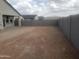 New home backyard features gravel surface and tall perimeter fencing at 18823 E Bruno Dr, Gold Canyon, AZ 85118