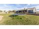 Large backyard featuring a trampoline, playground and lush green lawn surrounding a beautiful home at 18934 E Happy Rd, Queen Creek, AZ 85142
