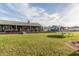 Expansive backyard with lush green grass, a detached home, and beautiful mountain views at 18934 E Happy Rd, Queen Creek, AZ 85142