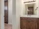 Bathroom showcasing a wood vanity with a white countertop and a dark wood cabinet at 18934 E Happy Rd, Queen Creek, AZ 85142