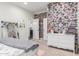 Inviting bedroom featuring a comfy bed, a dresser, and a collage wall of photos at 18934 E Happy Rd, Queen Creek, AZ 85142