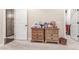 Cozy bedroom with a dresser, two doors, and carpet flooring at 18934 E Happy Rd, Queen Creek, AZ 85142