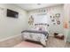 Charming bedroom with a cozy bed, decorative wall art, and a soft pink rug at 18934 E Happy Rd, Queen Creek, AZ 85142