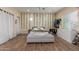 Bedroom featuring wood floors, vine accents, and a large window with natural light at 18934 E Happy Rd, Queen Creek, AZ 85142