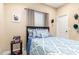Simple bedroom with a classic bed, a desk, and carpet flooring at 18934 E Happy Rd, Queen Creek, AZ 85142