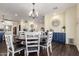 Open-concept dining area boasts a round dining table with dark wood floors and custom cabinetry at 18934 E Happy Rd, Queen Creek, AZ 85142