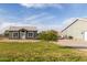 A grassy yard with a quaint home addition and large detached garage at 18934 E Happy Rd, Queen Creek, AZ 85142