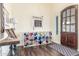 A view of a home's foyer featuring a dark wood door, colorful storage and decorative details at 18934 E Happy Rd, Queen Creek, AZ 85142