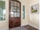 Welcoming foyer with a solid wood front door, decorative rug, and natural lighting at 18934 E Happy Rd, Queen Creek, AZ 85142
