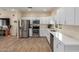 Kitchen with white cabinetry, stainless steel appliances, and modern countertops at 18934 E Happy Rd, Queen Creek, AZ 85142