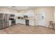 Kitchen featuring white cabinets, stainless steel appliances, and wood flooring at 18934 E Happy Rd, Queen Creek, AZ 85142