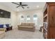 Living room with large arched windows, comfortable seating, and a beautiful built-in bookcase at 18934 E Happy Rd, Queen Creek, AZ 85142
