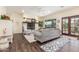 Cozy living room featuring a stone fireplace, wood floors, and comfortable seating area at 18934 E Happy Rd, Queen Creek, AZ 85142