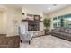 Comfortable living room showcasing a stone fireplace, wood floors, and stylish decor at 18934 E Happy Rd, Queen Creek, AZ 85142