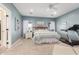 Bright main bedroom featuring a ceiling fan, neutral walls, and a cozy seating area at 18934 E Happy Rd, Queen Creek, AZ 85142