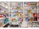 Walk-in pantry featuring extensive shelving filled with an array of food items and household goods at 18934 E Happy Rd, Queen Creek, AZ 85142