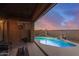 Inviting backyard featuring a sparkling pool with a waterfall, enhanced by a covered patio with cozy seating at 1916 E Dubois Ave, Gilbert, AZ 85298