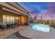 Captivating backyard displaying a stunning pool with a rock waterfall and a covered patio, perfect for outdoor enjoyment at 1916 E Dubois Ave, Gilbert, AZ 85298