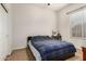 Bedroom with a bed, desk, and window, offering a versatile space for rest and productivity at 1916 E Dubois Ave, Gilbert, AZ 85298