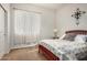 Comfortable bedroom with a plush bed, warm carpeting, and a window with natural light, offering a cozy retreat at 1916 E Dubois Ave, Gilbert, AZ 85298