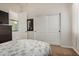 Well-lit bedroom featuring a comfortable bed, large closet, and a view into the ensuite bathroom at 1916 E Dubois Ave, Gilbert, AZ 85298