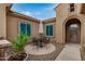 Cozy courtyard with outdoor seating, desert landscaping, and an arched doorway to the home at 1916 E Dubois Ave, Gilbert, AZ 85298