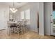 Bright dining area featuring a modern table with seating for six, tile floors, and ample natural light at 1916 E Dubois Ave, Gilbert, AZ 85298