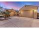 Stunning home exterior featuring attached garages, desert landscaping, and a stone courtyard entrance at 1916 E Dubois Ave, Gilbert, AZ 85298