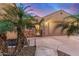 Exterior view of a home with a stone-accented entry, a seating bench, and desert landscaping at 1916 E Dubois Ave, Gilbert, AZ 85298