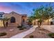 Charming home with desert landscaping, stone accents, and a winding walkway to the inviting entrance at 1916 E Dubois Ave, Gilbert, AZ 85298