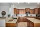 Kitchen featuring granite countertops, stainless sink, tile flooring and wooden cabinets at 1916 E Dubois Ave, Gilbert, AZ 85298