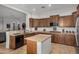 Bright kitchen area showcasing stainless steel appliances and granite countertops at 1916 E Dubois Ave, Gilbert, AZ 85298