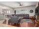 Spacious living room showcasing a sectional sofa, hardwood floors, and a seamless flow to the kitchen at 1916 E Dubois Ave, Gilbert, AZ 85298