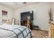 Bedroom area with a TV, fireplace and neutral colored walls at 1916 E Dubois Ave, Gilbert, AZ 85298