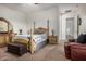 Spacious bedroom featuring a wooden bed frame, dresser, ceiling fan, and neutral colored walls at 1916 E Dubois Ave, Gilbert, AZ 85298
