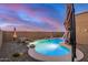 Beautiful in-ground pool features an adjacent rock waterfall and spa, creating a relaxing backyard oasis at 1916 E Dubois Ave, Gilbert, AZ 85298