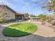 Large backyard featuring artificial grass, gravel landscaping, and a built in bar at 20075 E Kestrel St, Queen Creek, AZ 85142