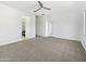 Bedroom with carpet, ceiling fan, and access to backyard at 20075 E Kestrel St, Queen Creek, AZ 85142