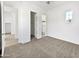 A neutral bedroom with soft carpeting and several doorways leading to closet and bathroom areas at 20075 E Kestrel St, Queen Creek, AZ 85142
