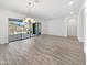 Spacious living room with tile floors, sliding glass doors, and a modern chandelier at 20075 E Kestrel St, Queen Creek, AZ 85142