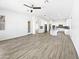 A bright and airy open-concept living room with wood-look tile flooring and abundant natural light at 20075 E Kestrel St, Queen Creek, AZ 85142