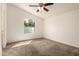 Bright bedroom with a vaulted ceiling, a ceiling fan, a large window and neutral carpet at 201 S Greenfield Rd # 144, Mesa, AZ 85206