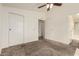 Bedroom featuring neutral carpet, large closet space, ceiling fan and an attached bathroom at 201 S Greenfield Rd # 144, Mesa, AZ 85206
