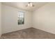 Bright bedroom featuring neutral carpet, a ceiling fan and a large window at 201 S Greenfield Rd # 144, Mesa, AZ 85206