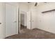 Bedroom featuring neutral carpet, ceiling fan, an entry door and a closet at 201 S Greenfield Rd # 144, Mesa, AZ 85206