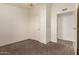 Bedroom featuring neutral carpet, ceiling fan, an entry door and an open closet at 201 S Greenfield Rd # 144, Mesa, AZ 85206