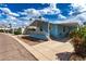 Quaint light blue home with covered parking and a cozy front porch in a friendly community at 201 S Greenfield Rd # 144, Mesa, AZ 85206