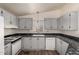 Bright kitchen featuring modern appliances, sleek counters and wood flooring at 201 S Greenfield Rd # 144, Mesa, AZ 85206